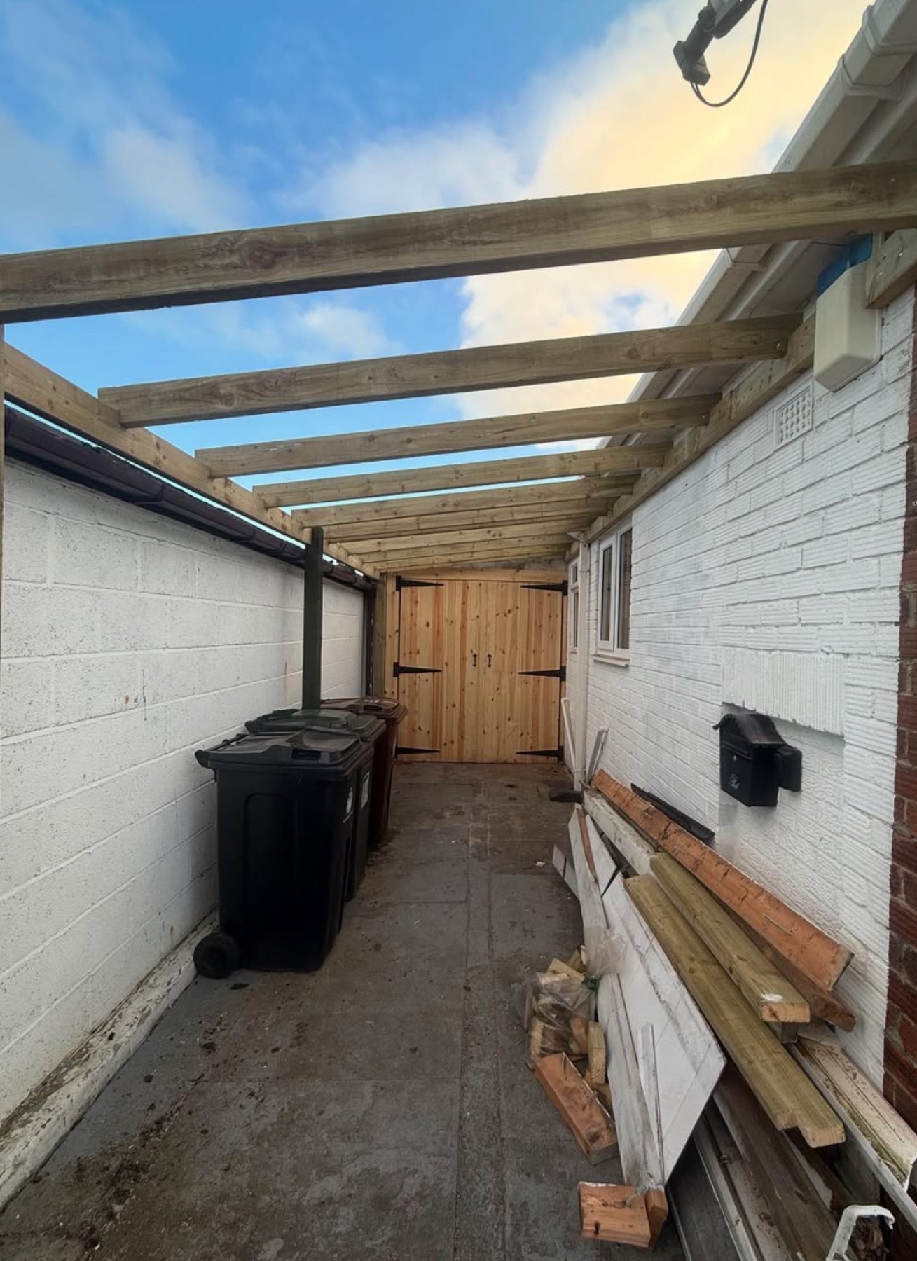 The open timber roof frame over the side passage before boarding