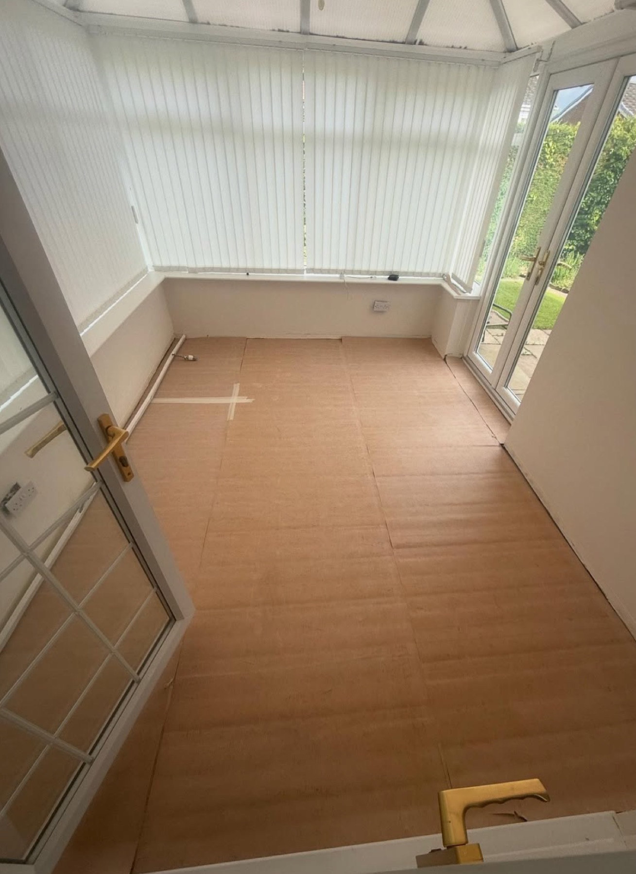 The conservatory with bare underlay boards down before the floor was laid