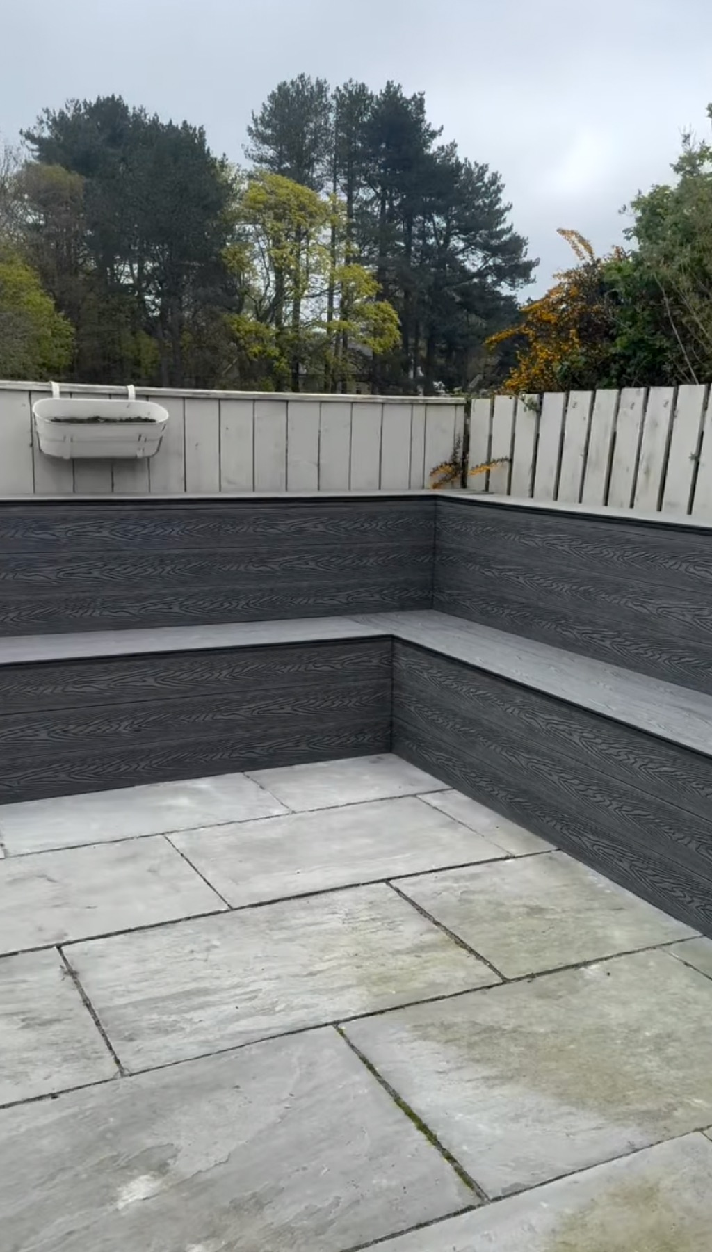 New grey composite-clad garden seating and planters
