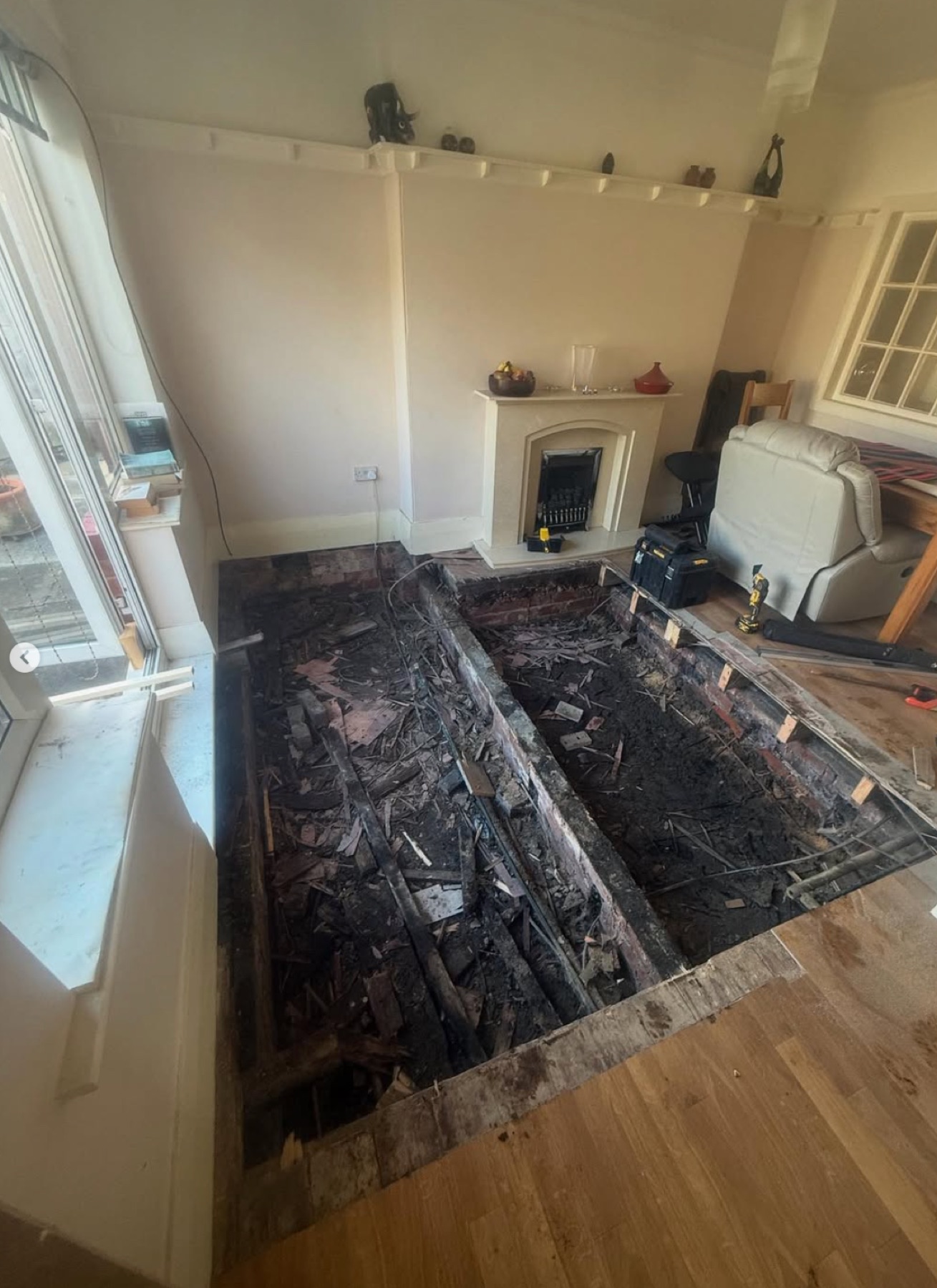 The living-room floor lifted back to bare joists and subfloor during renovation