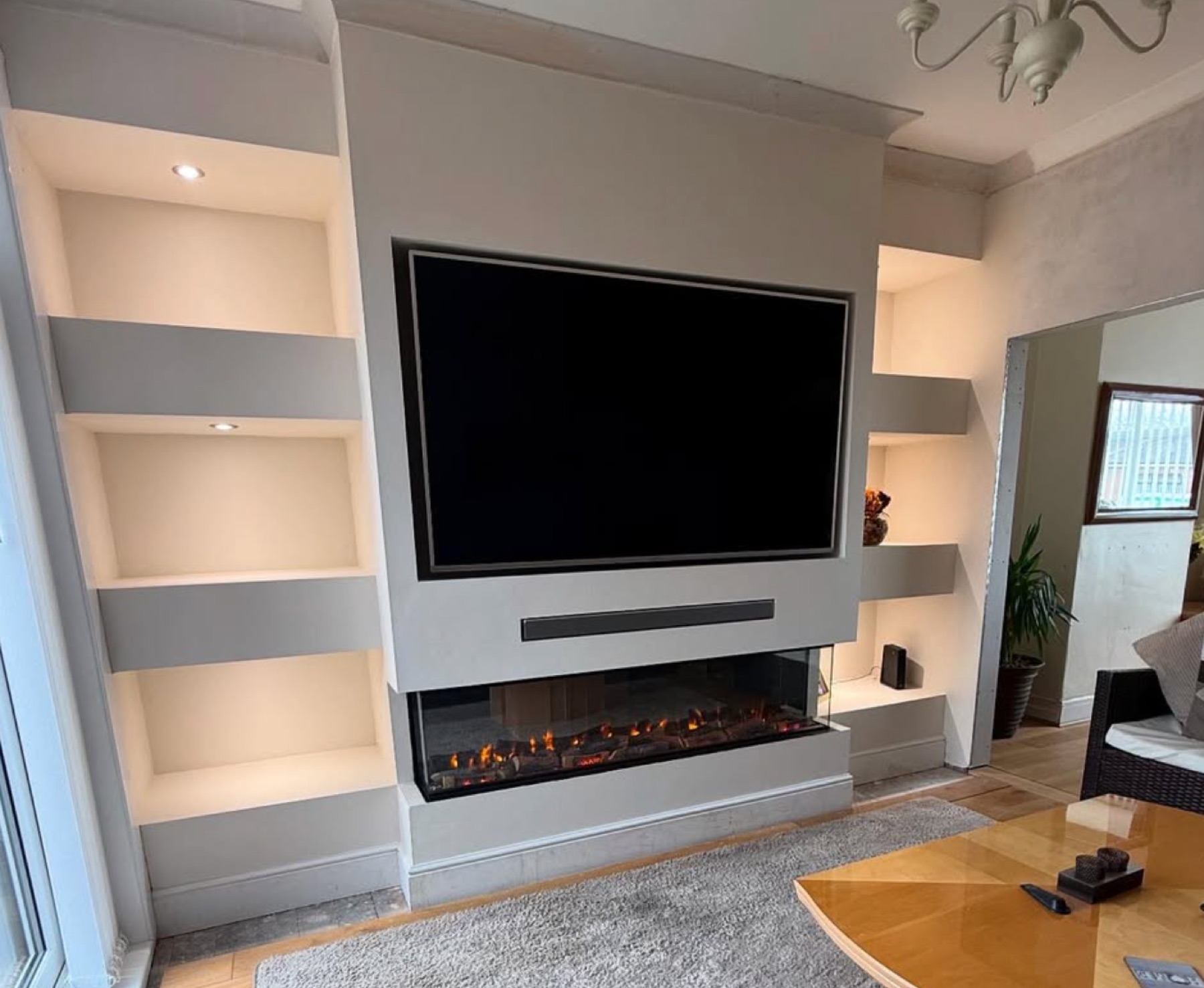 Media wall with inset fire and lit shelving