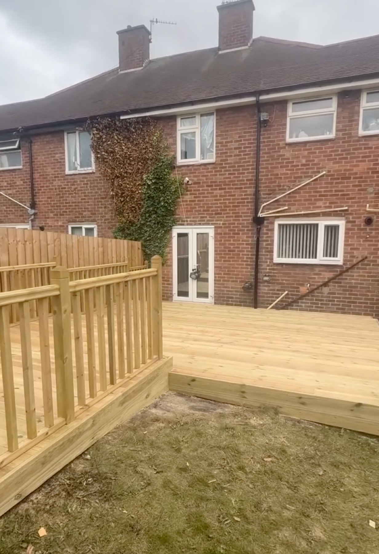 Raised timber garden decking with balustrade