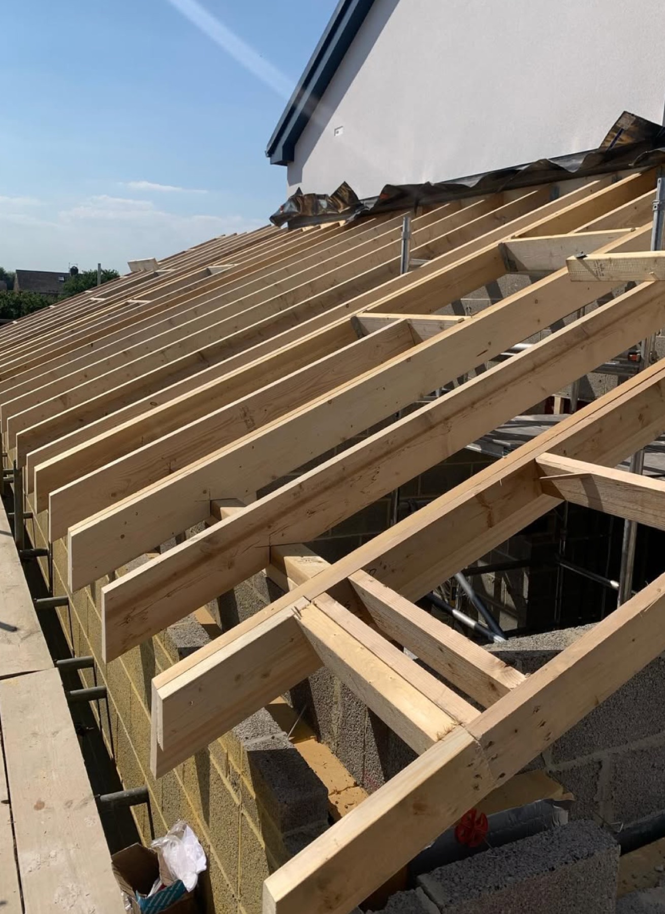 Structural cut-roof carpentry in progress, new timber rafters and joists