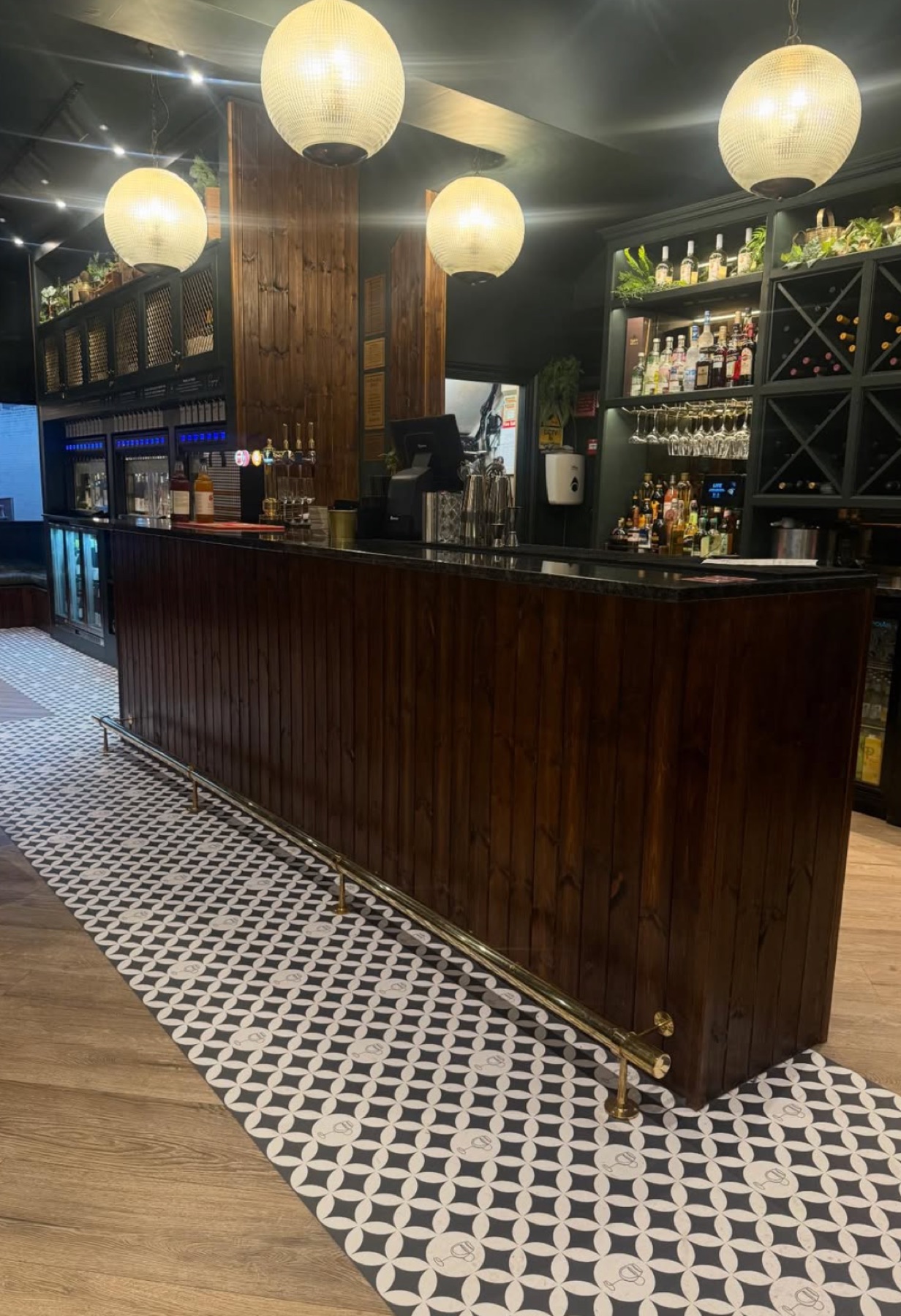 Finished wine bar with timber-clad bar and wine racks