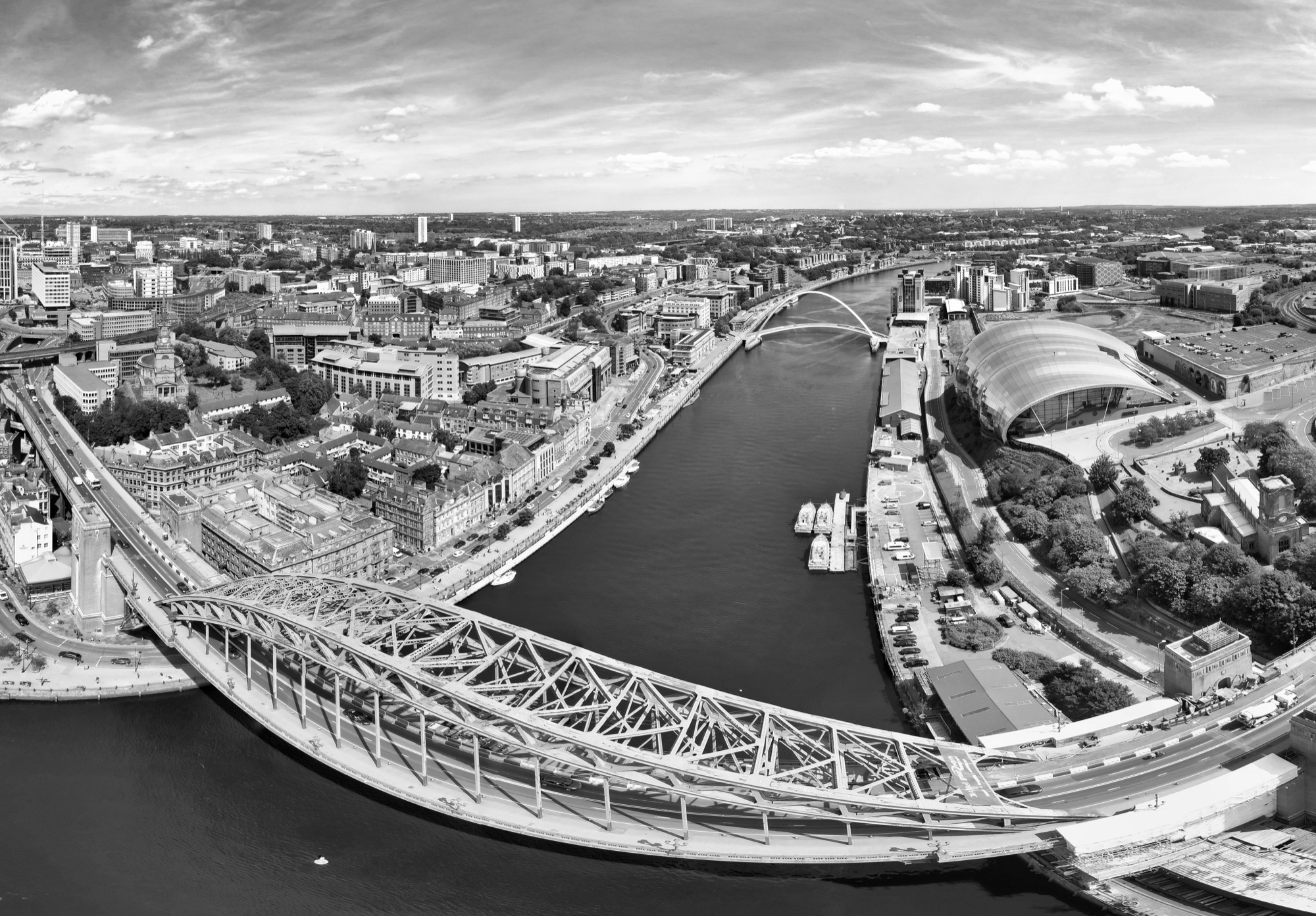 Black and white aerial view of the Newcastle and Gateshead quayside with the Tyne bridges